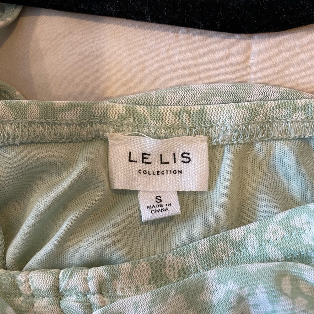 Pastel green and white floral skirt and crop top two piece set.